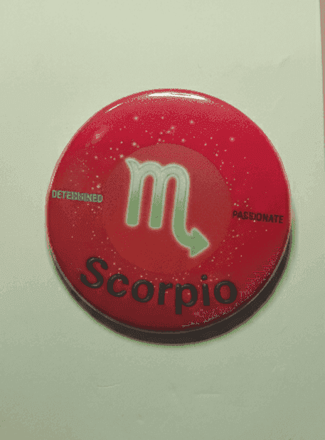 Scorpio zodiac badge with red ombre background and white symbol