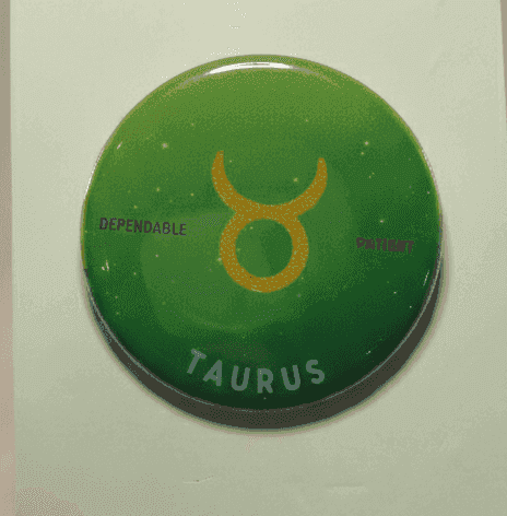 Taurus zodiac badge with green ombré background and gold symbol