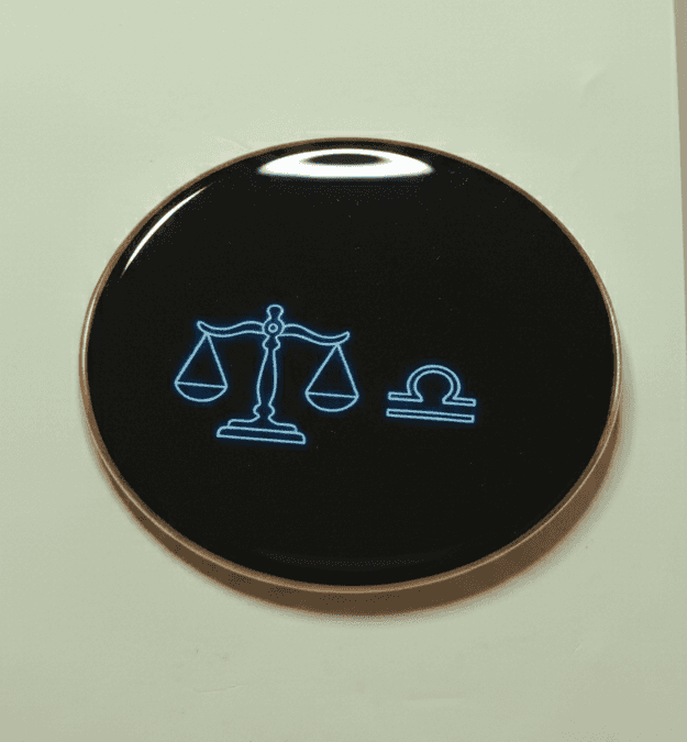 Libra zodiac neon symbol on black round magnet