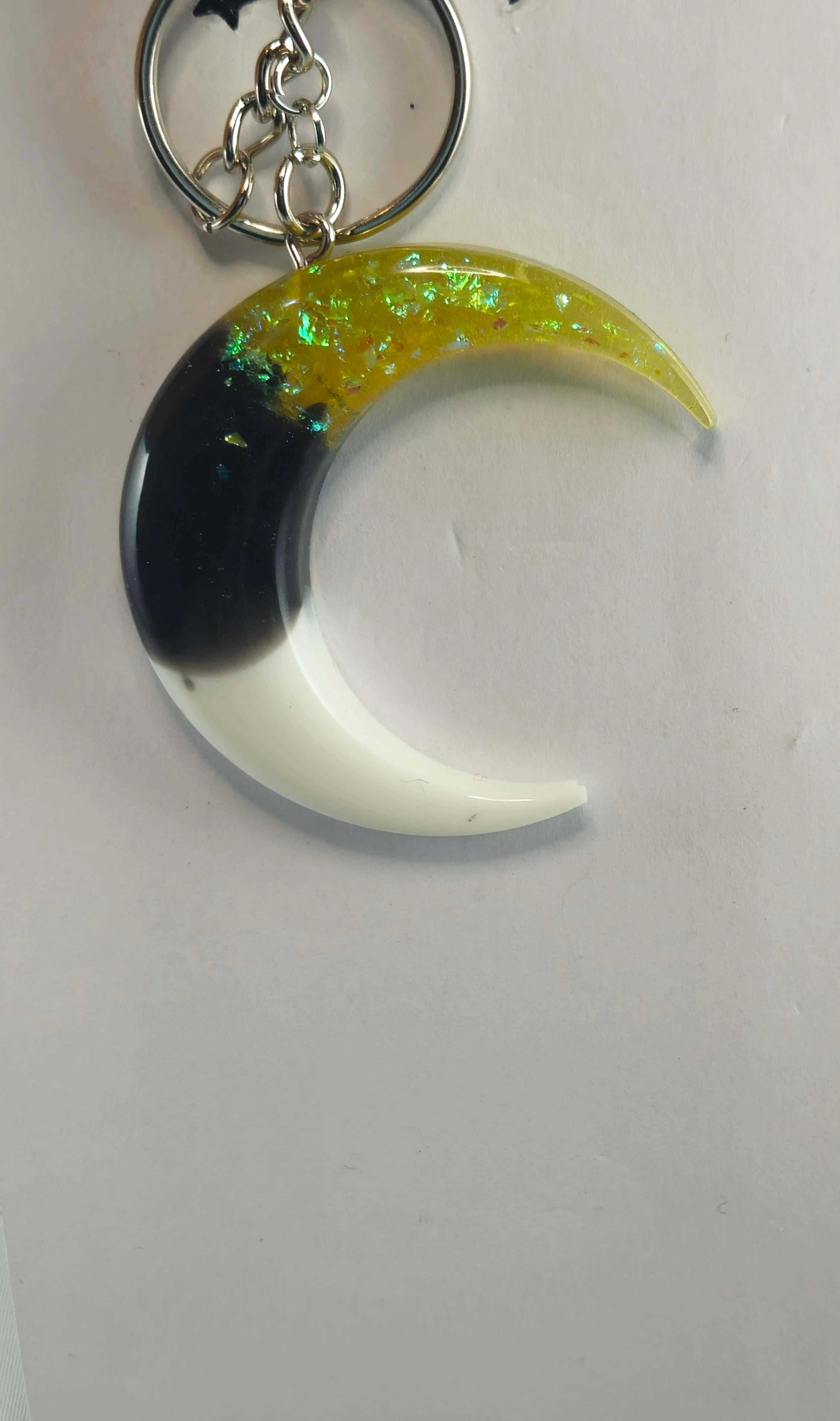 Yellow and black crescent moon keychain with iridescent flakes