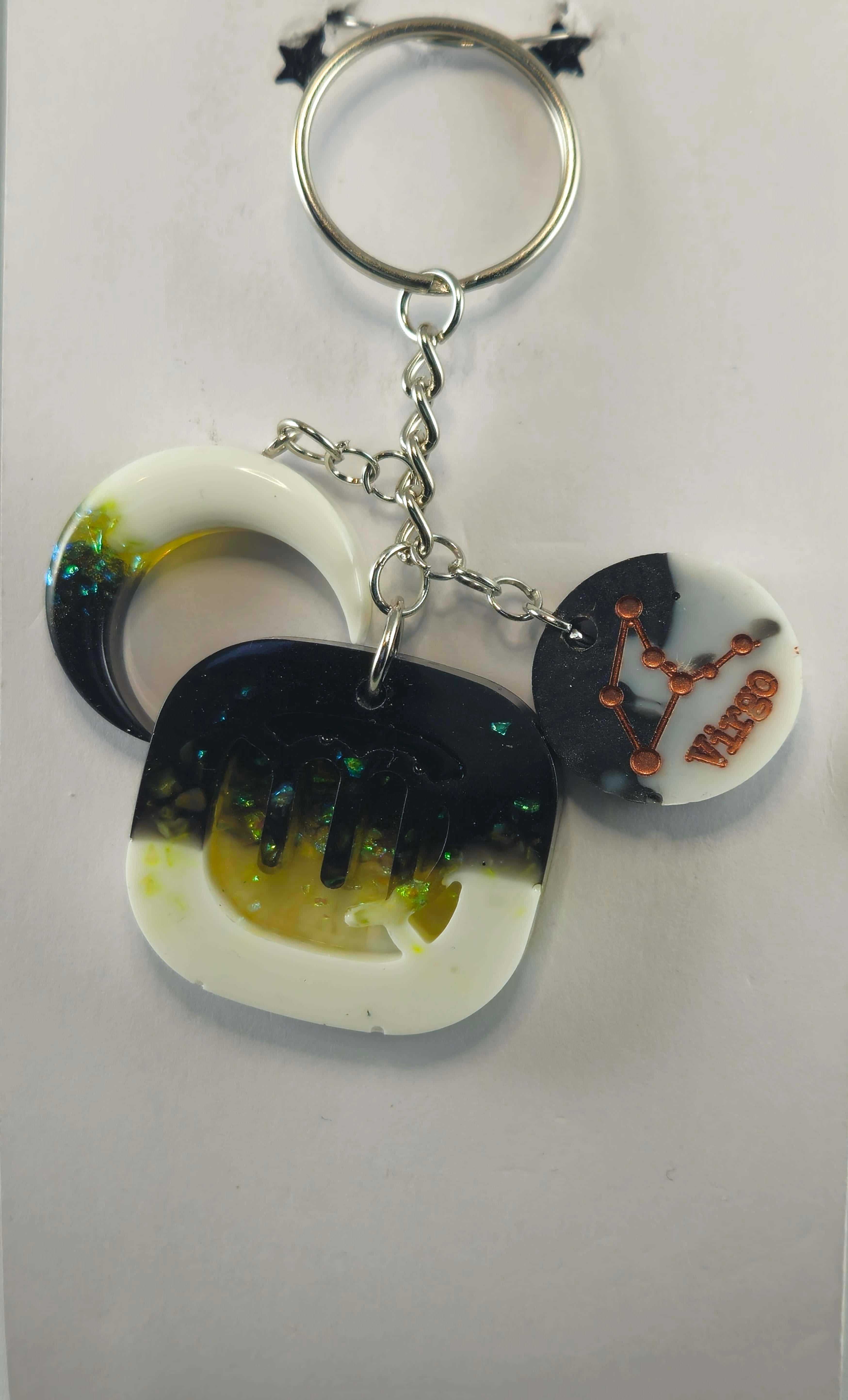 Miner's Galore Virgo zodiac keychain with moon and star design, featuring a white and black color scheme, attached to a silver keyring