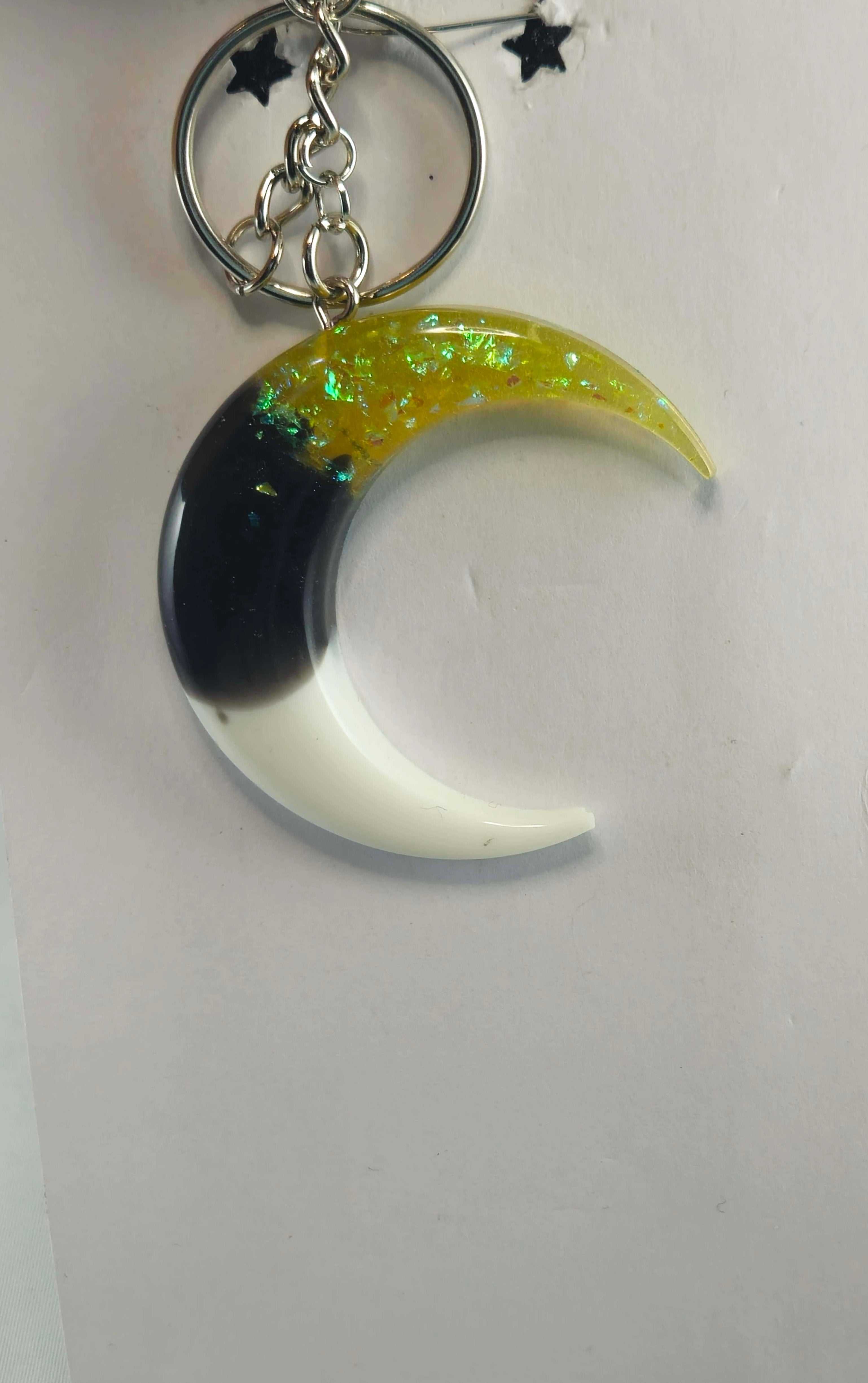 Yellow and black crescent moon keychain with iridescent flakes and glossy finish