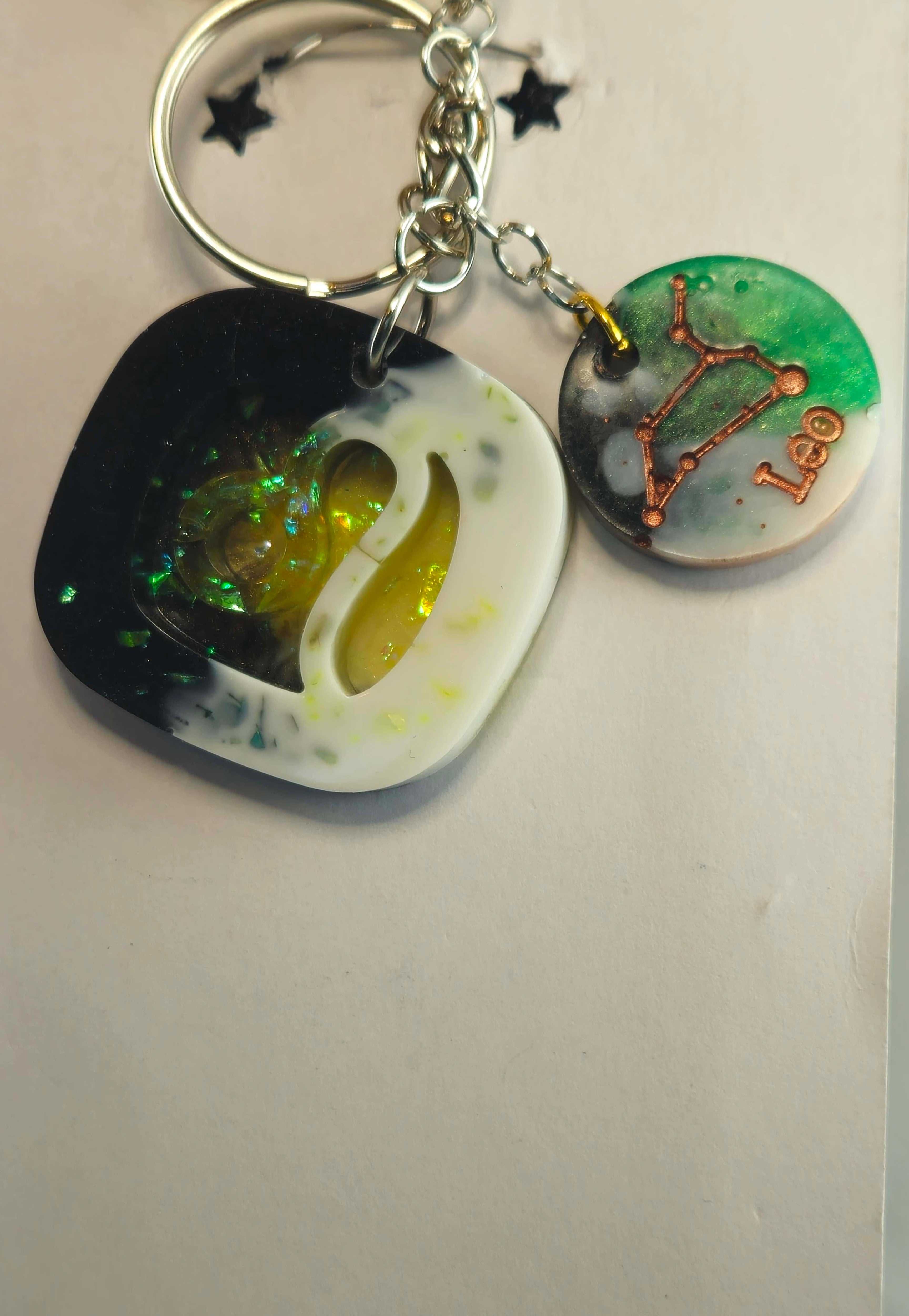Miner's Galore Leo zodiac keychain with white, black, and iridescent green resin, featuring constellation and Leo inscription