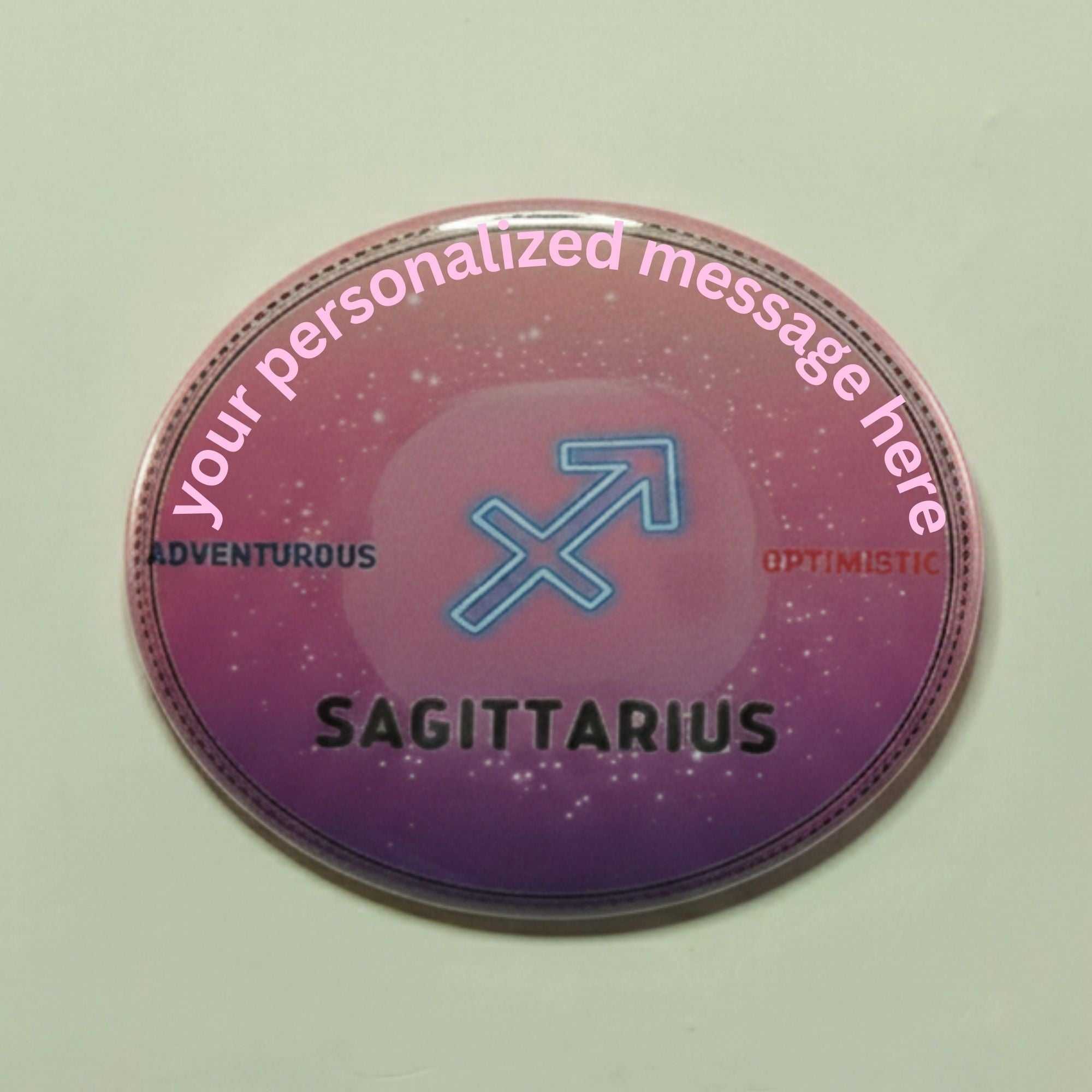 Pink purple ombre zodiac button with Sagittarius symbol