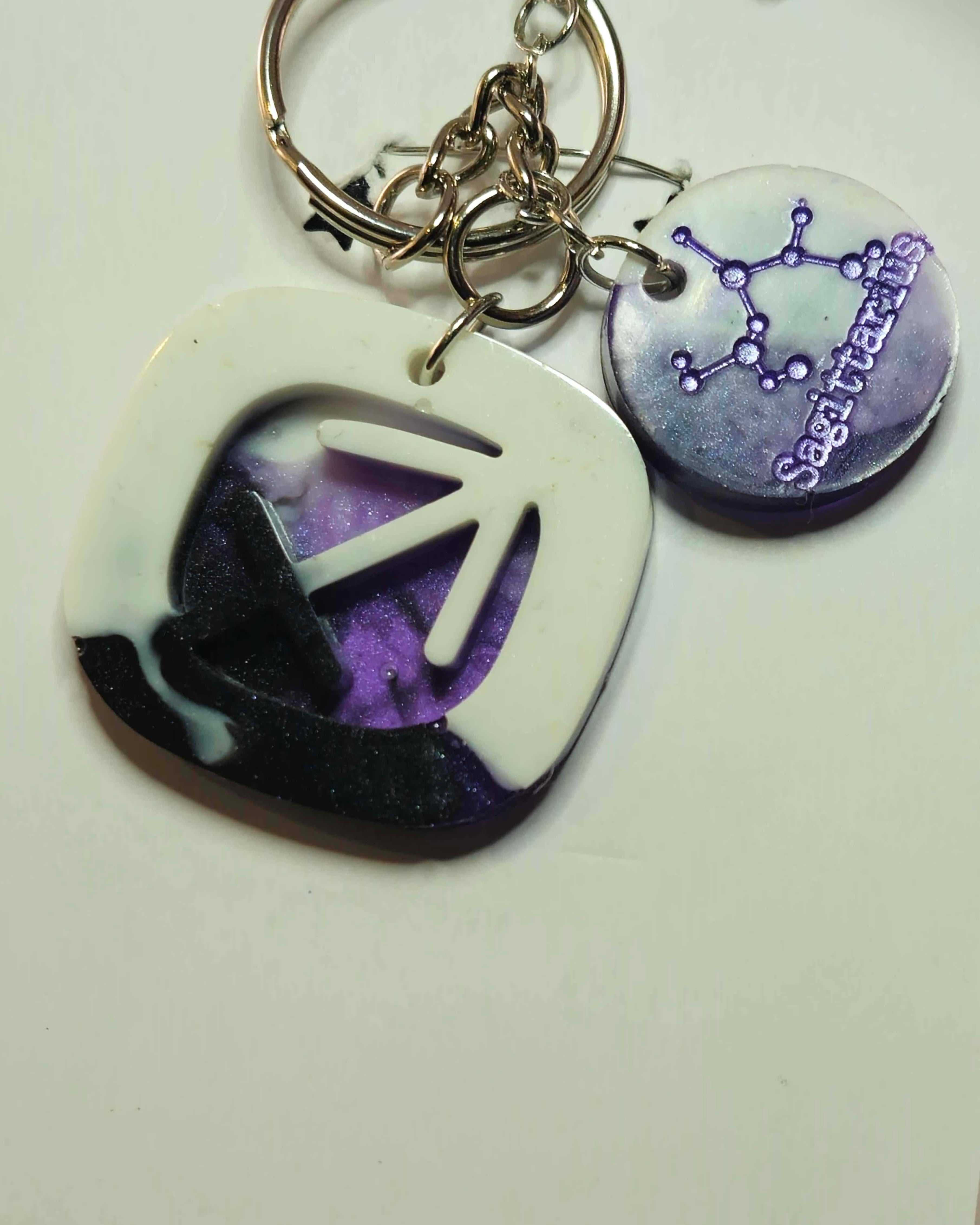 Sagittarius zodiac keychain with purple charm and constellation-themed accessory