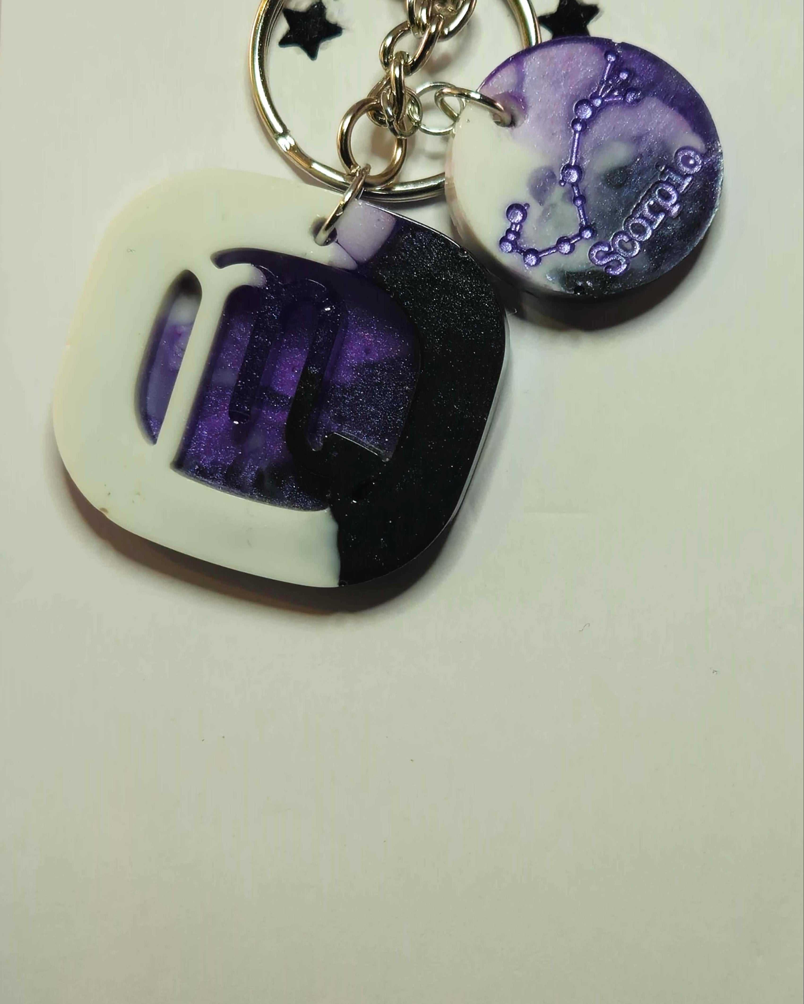The Stormy Weather Scorpio Keychain features a square-shaped Scorpio design that offers a clean and contemporary appearance