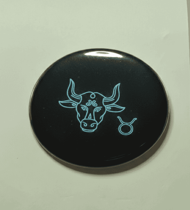 Neon Taurus zodiac badge with bull and Taurus symbol