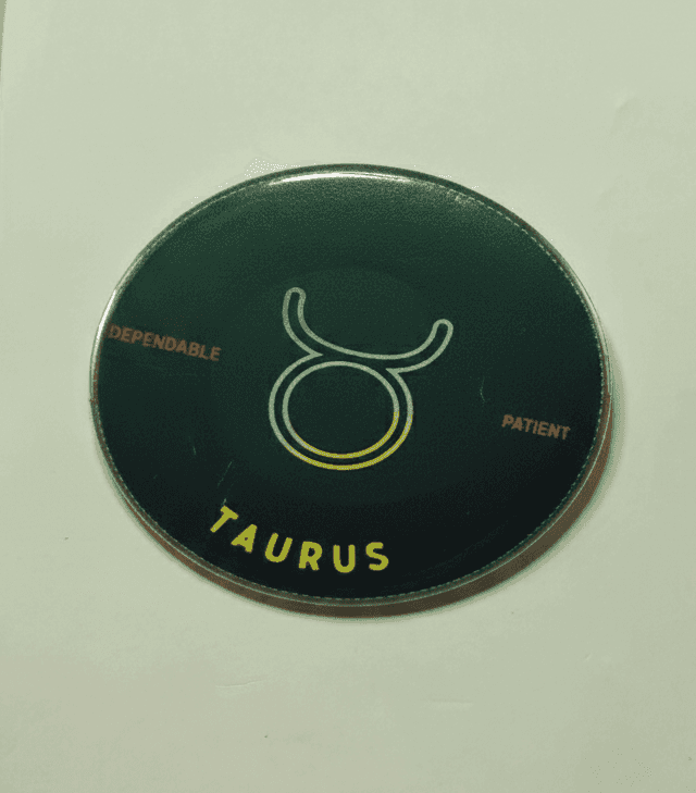 Taurus zodiac badge with green ombré design and bull symbol