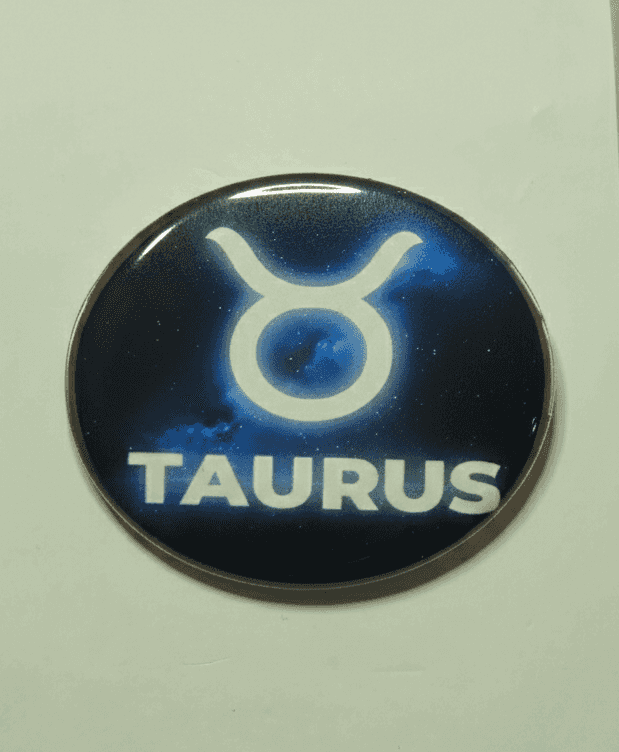 Taurus zodiac badge with cosmic blue starry background